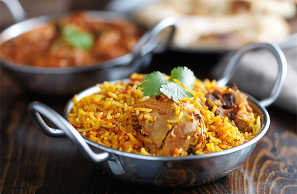 Two bowls of food on a table.