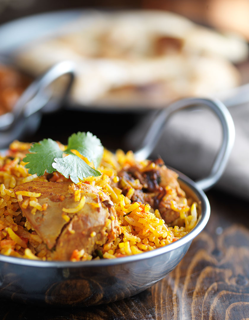 A bowl of food on a wooden table.